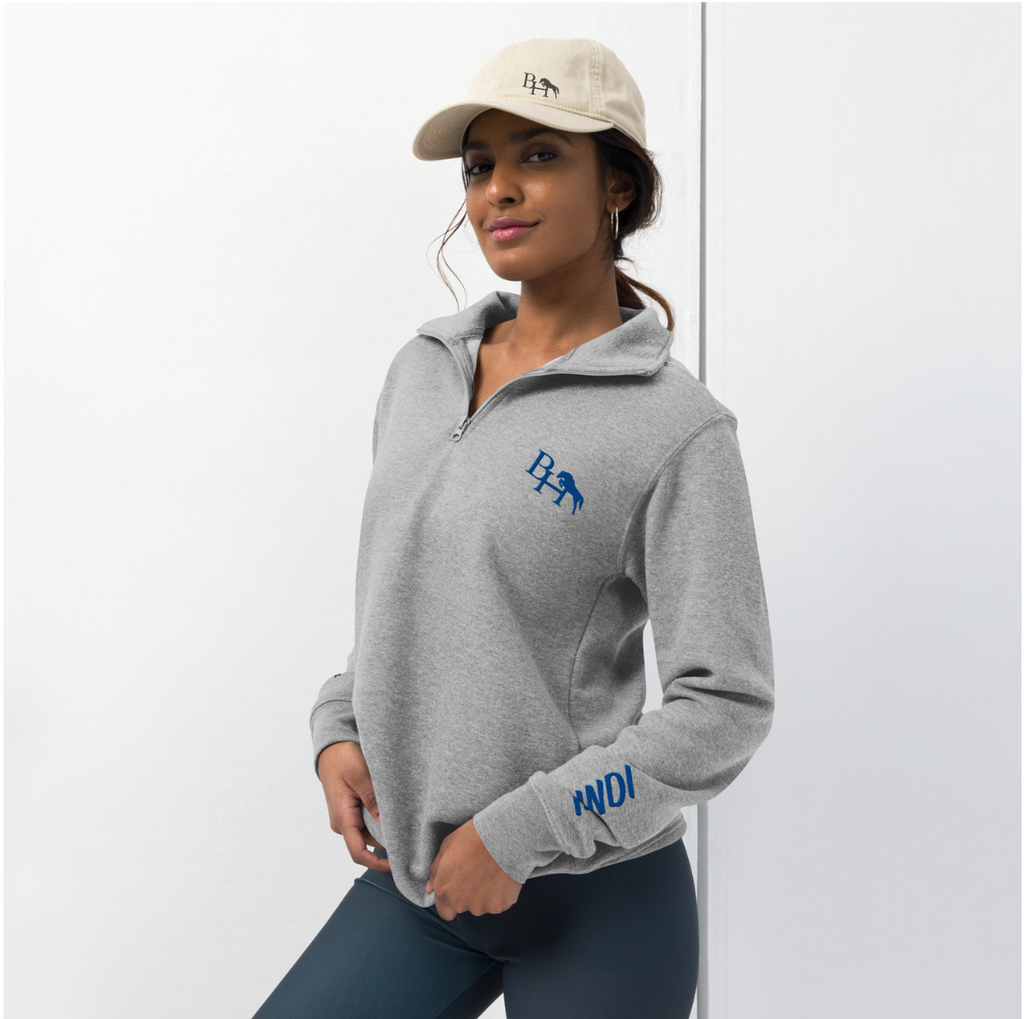 Person wearing a gray hoodie with branding on a white background